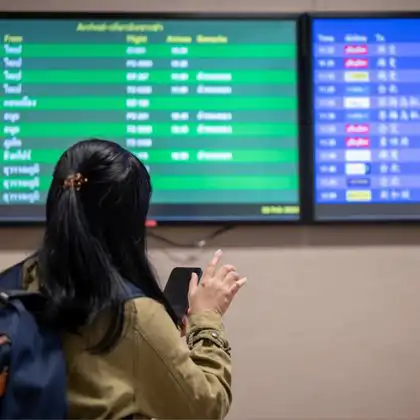 Mulher olhando celular em um aeroporto