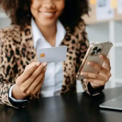 Mulher sorrindo segurando celular para abrir conta no Revolut.