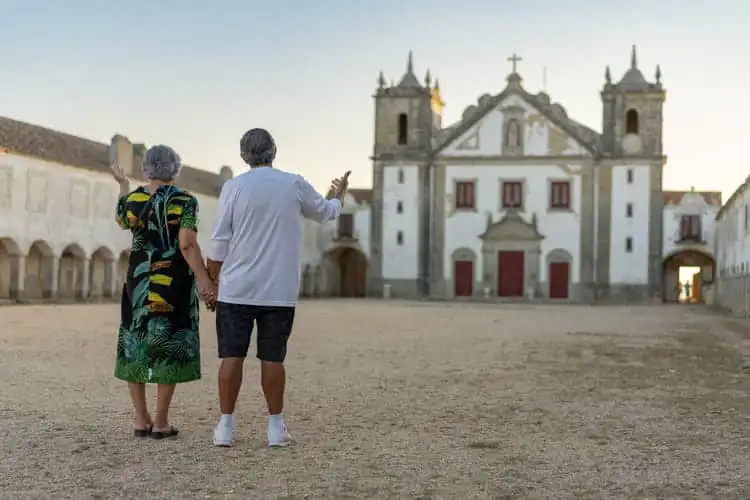 Casal de aposentados em frente a uma em Portugal.