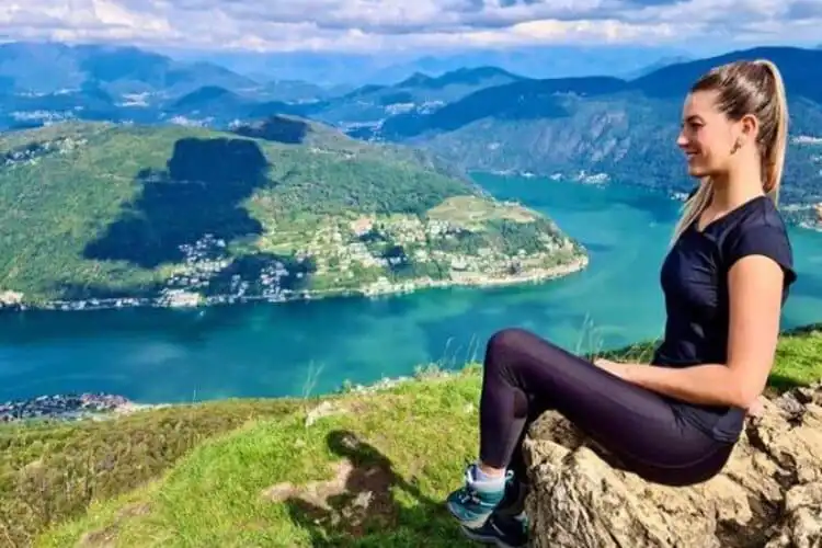 Brasileira sentada no alto da montanha na Suíça