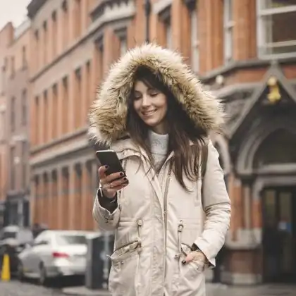 Mulher em Dublin olhando seu celular com chip celular Irlanda