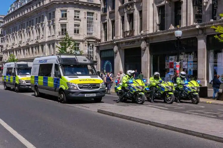 Viaturas e motos policiais reforçando a segurança da Inglaterra em rua de Londres. 