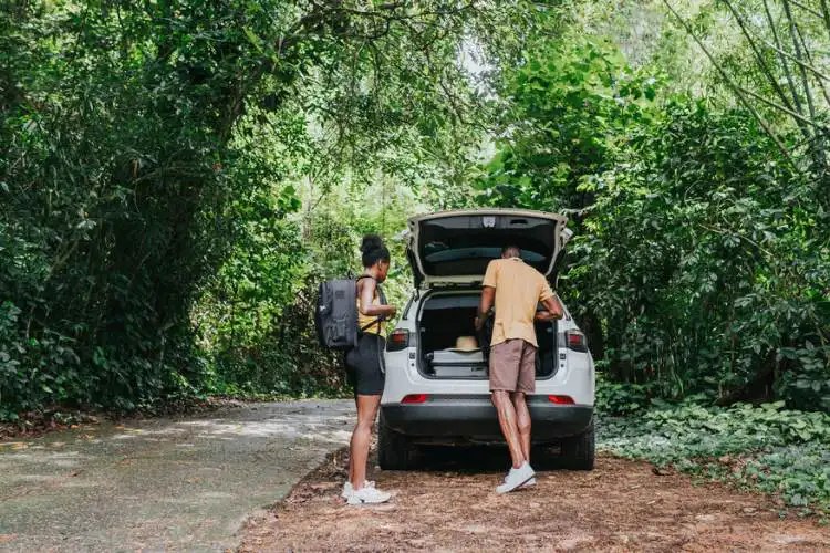 Casal arrumando bagagem no porta-malas