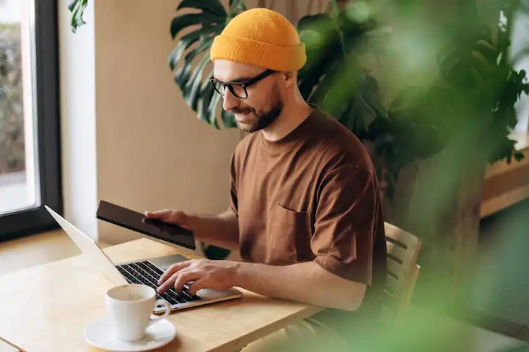 Homem usando notebook, trabalhando em casa